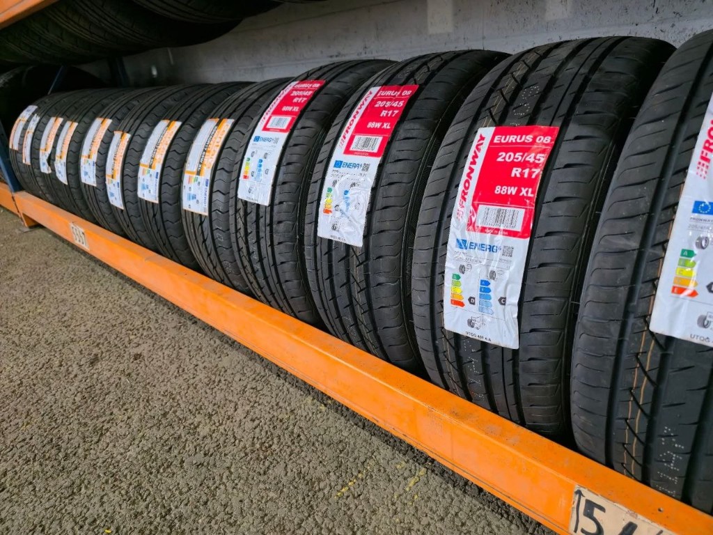 New tyres with EU labels on orange racking